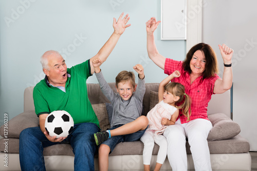 Family Watching Football Match On Television
