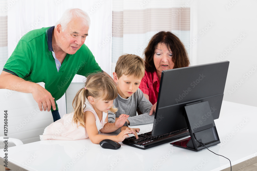 Multi Generation Family Using Desktop At Home Multi Generation Family Using Desktop At Home