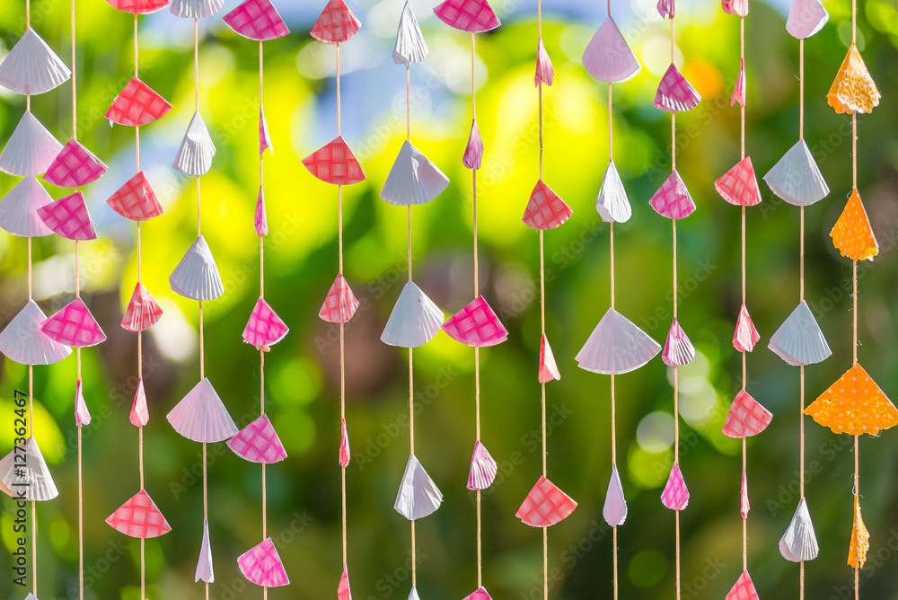 Triangle papers hanging on the rope with bokeh nature background