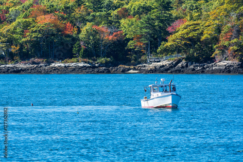 Lobster fishing boat in autumn against deep blue ocean water in coastal Maine, New England © Tabor Chichakly