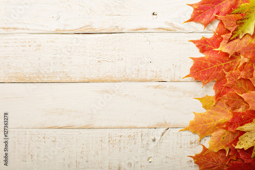 Fall leaves frame on whooden background photo