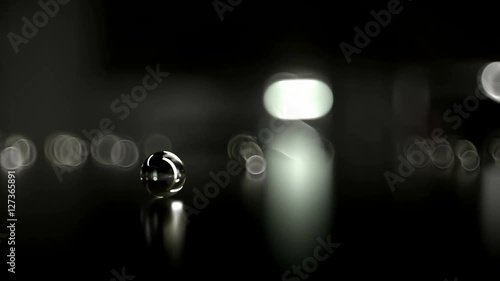 Are scattered glass beads. Dark studio. 4k Ultra HD photo