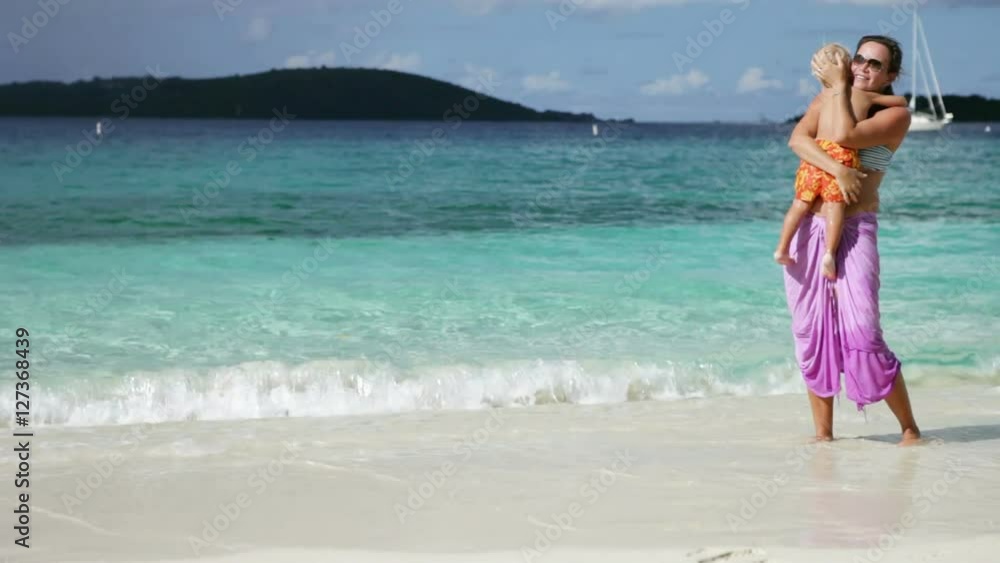 mother and child kissing and hugging on tropical beach in the Caribbean mother and child kissing and hugging on tropical beach in the Caribbean