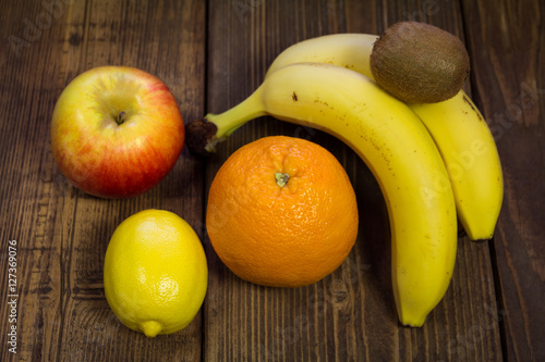 Mixed fruit on a wooden background