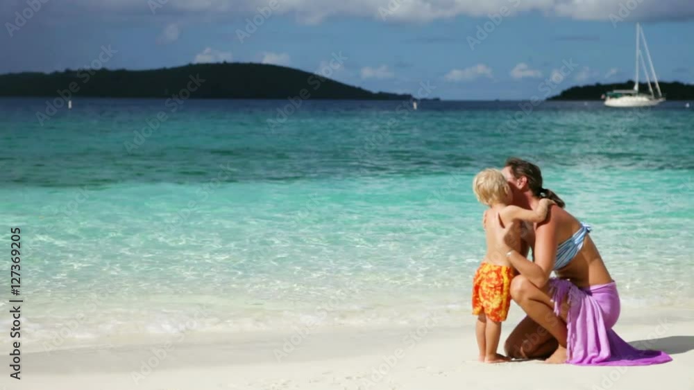 mother and child kissing and hugging on tropical beach in the Caribbean mother and child kissing and hugging on tropical beach in the Caribbean