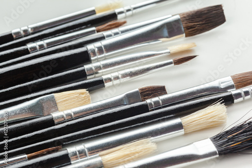 close up of paint brushes on white background