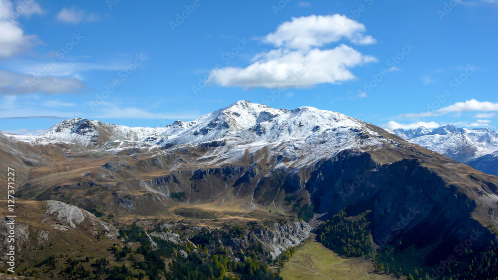 a view of the Swiss Alps near the national park after the first snowfall in the fall