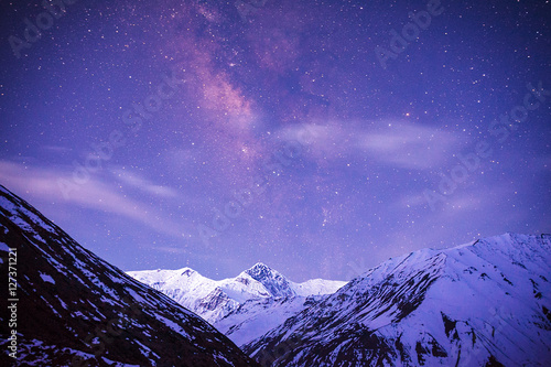 Milky Way over the mountains of the Himalayas at the time of the transition from night to sunrise. Annapurna III (7555 m) peak. photo