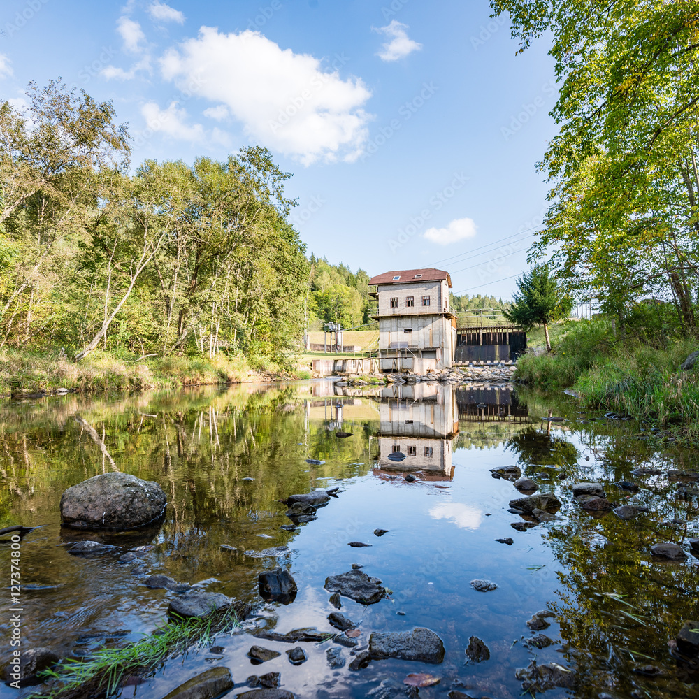 Fototapeta premium electric mill on a river in summer