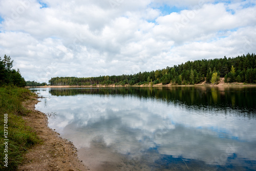 calm lake with reflections of clouds in summer