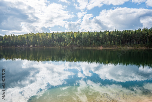 Fototapeta Naklejka Na Ścianę i Meble -  calm lake with reflections of clouds  in summer