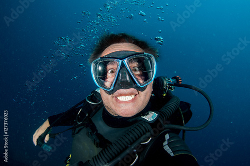 Scuba diver smiling underwater selfie portrait in the ocean