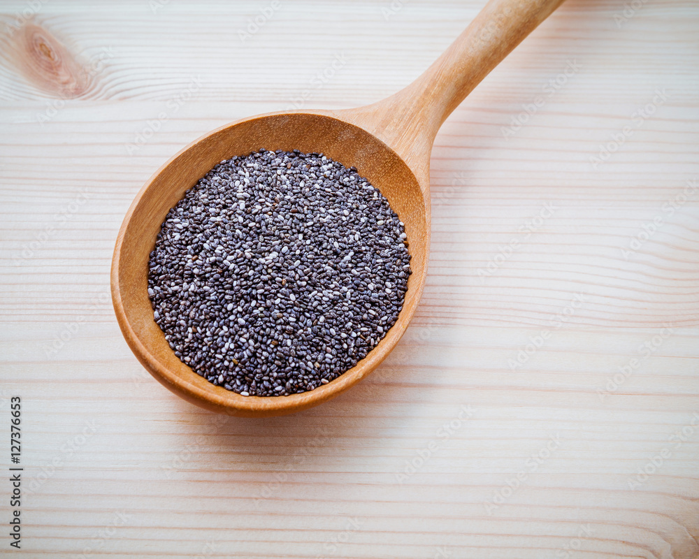 Nutritious chia seeds in wooden spoon for diet foods ingredient Nutritious chia seeds in wooden spoon for diet foods ingredient