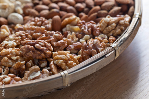 Different nuts in old wooden dish