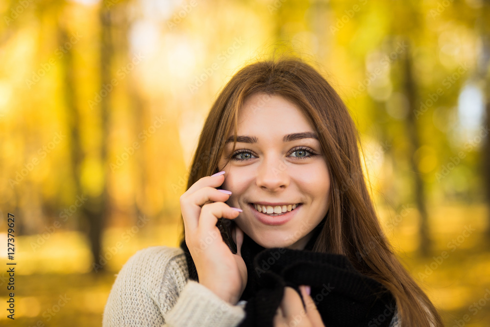 Portrait of girl speak on phone in sunny autumn park Portrait of girl speak on phone in sunny autumn park