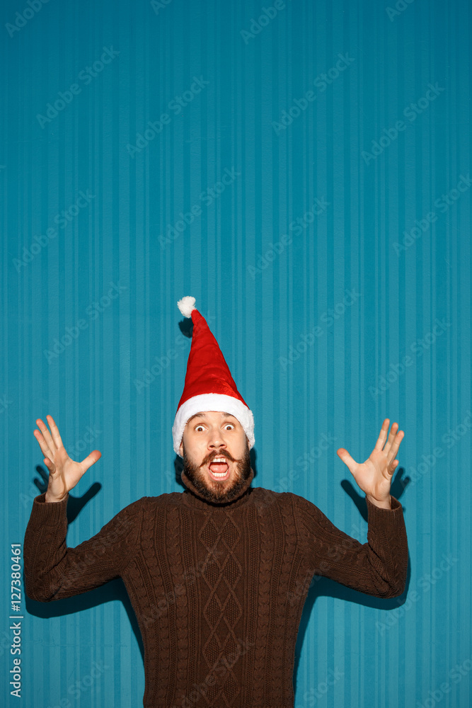 Surprised christmas man wearing a santa hat