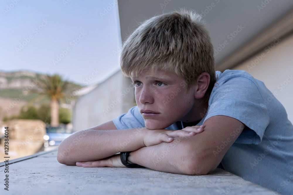 Portrait of a teenager leaning on the wall of a terrace Portrait of a teenager leaning on the wall of a terrace