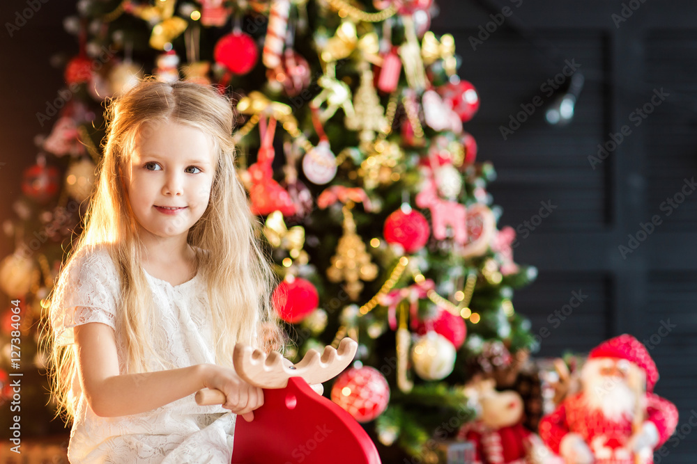 Little cute girl near christmas tree