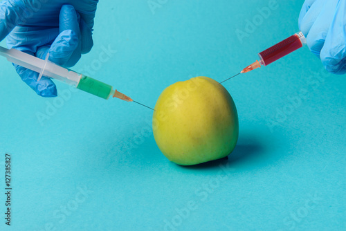 Chemical additives in food or genetically modified fruit concept