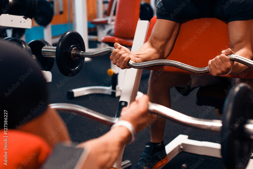 Athlete doing exercise on a simulator in the gym