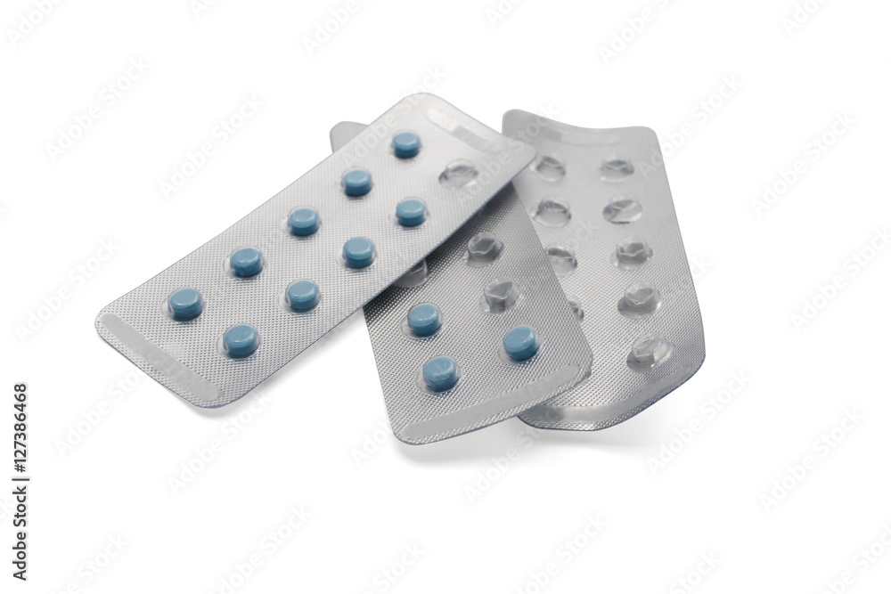 Blue pills in packages and empty packages isolated on white background Blue pills in packages and empty packages isolated on white background