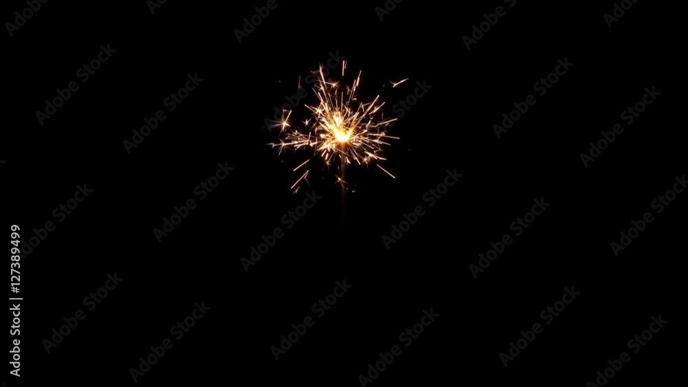 Centrally positioned firework sparkler burning from start to end in real time isolated. Full size uncropped expanded frame. Gun powder sparks shot against deep dark background. Centrally positioned firework sparkler burning from start to end in real time isolated. Full size uncropped expanded frame. Gun powder sparks shot against deep dark background.