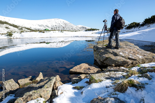 Wallpaper Mural Photographer taking photos of beautiful landscape in the mountain lake. Winter lake. Travel inspiration and motivation, beautiful landscape. Torontodigital.ca