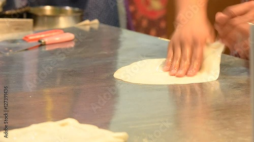 A woman used oil to help flatten roti dough bread, Texture background
 