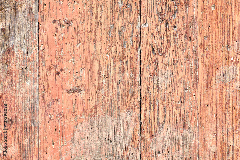 Old wooden planks painted with pink paint cracked by a rustic ba Old wooden planks painted with pink paint cracked by a rustic ba