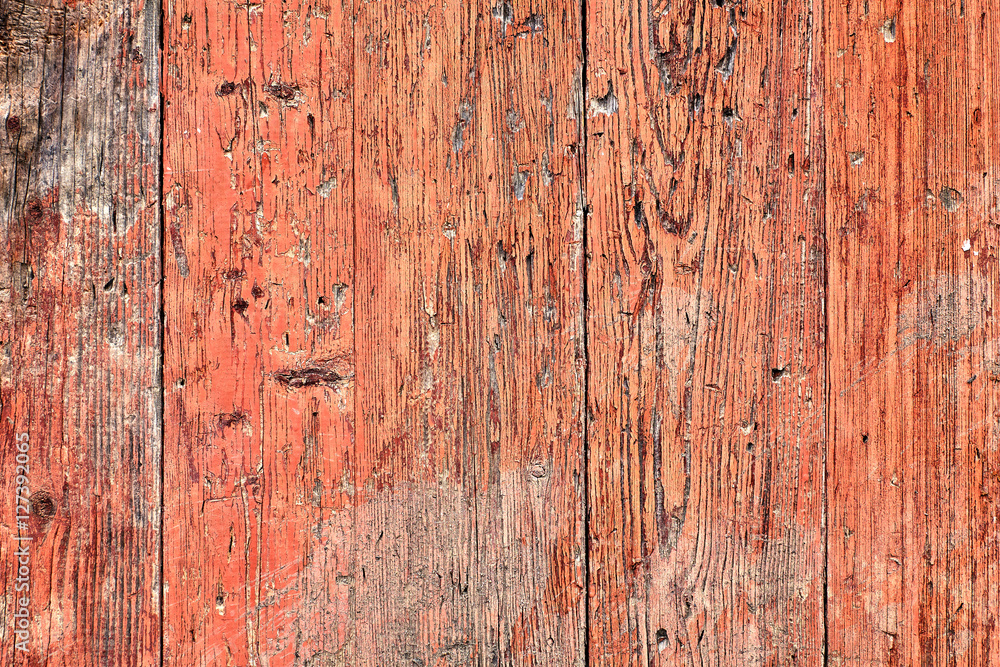 Naklejka premium Old wooden planks painted with dark pink paint cracked by a rust