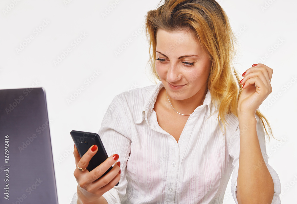 Happy young woman watching her smart phone in office Happy young woman watching her smart phone in office