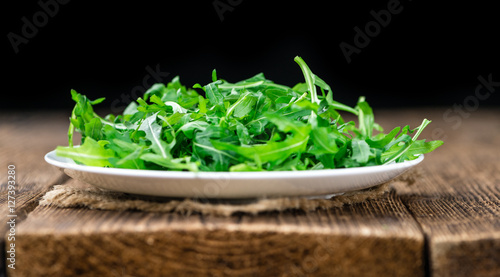 Wooden table with fresh Arugula
