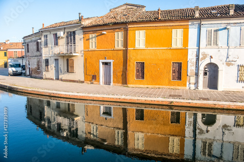 old orange building water reflection