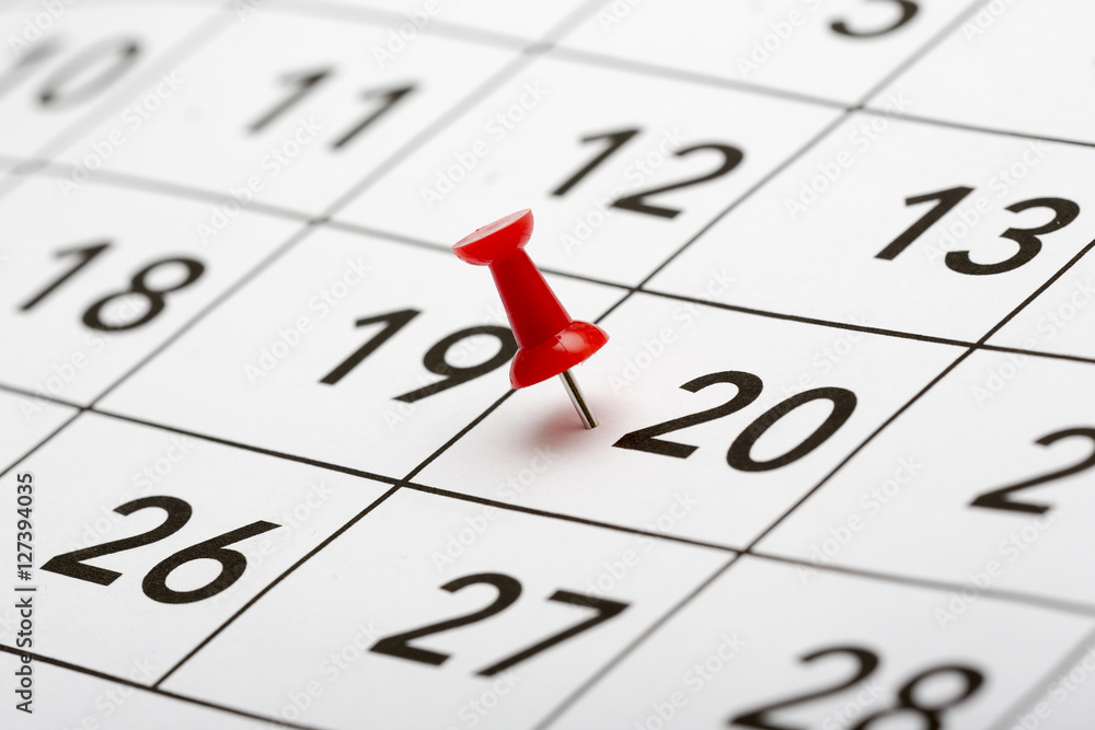 Pin on the date number 20. The twentieth day of the month is marked with a red thumbtack. Focus point on the red pin. Pin on the date number 20. The twentieth day of the month is marked with a red thumbtack. Focus point on the red pin.
