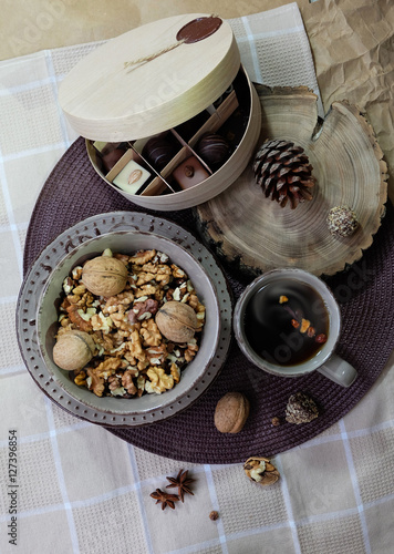 Tea, candies, walnuts in a bowl.