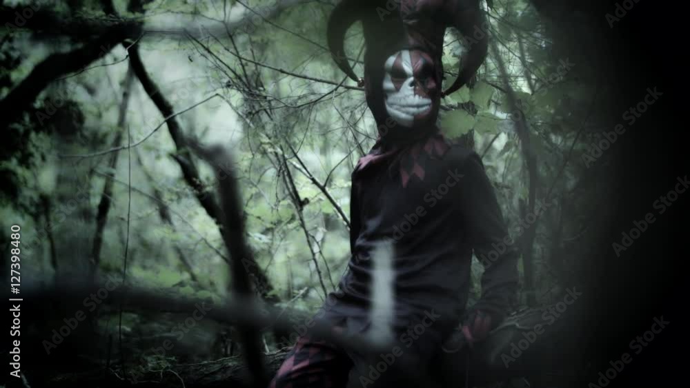 4k Halloween Shot of a Child in Joker Costume Hiding in the Woods 4k Halloween Shot of a Child in Joker Costume Hiding in the Woods