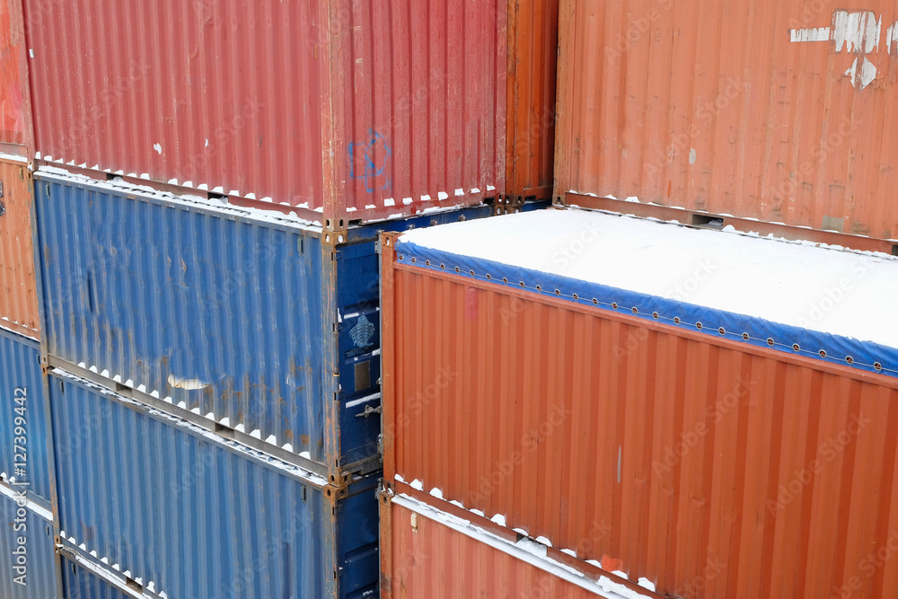 snow-covered cargo containers on the terminal of the Northern port