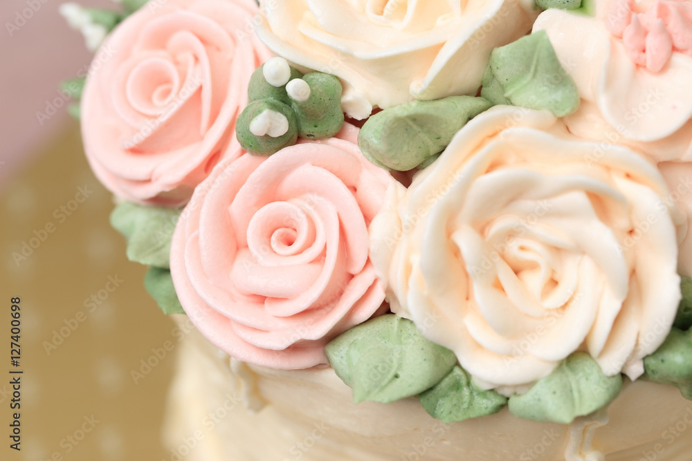 Close up of Wedding or birthday cake decorated with flowers made Close up of Wedding or birthday cake decorated with flowers made