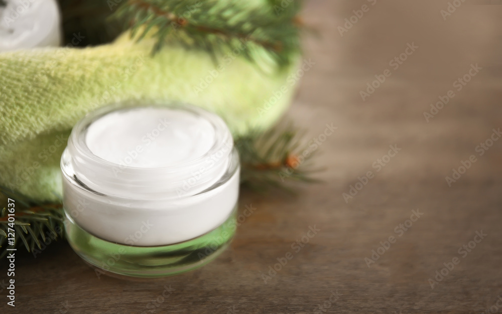 Cream and pine branches on wooden background Cream and pine branches on wooden background