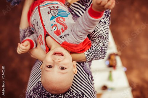 Little boy playing with his mother at home