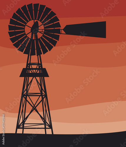 silhouette of a water pumping windmill