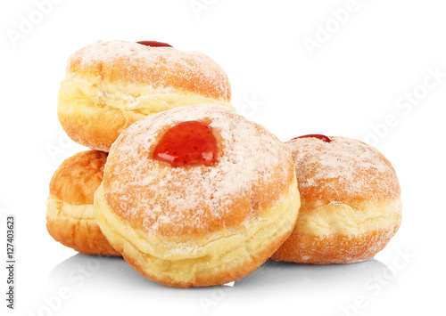 Tasty donuts with jam on white background. Hanukkah celebration concept
