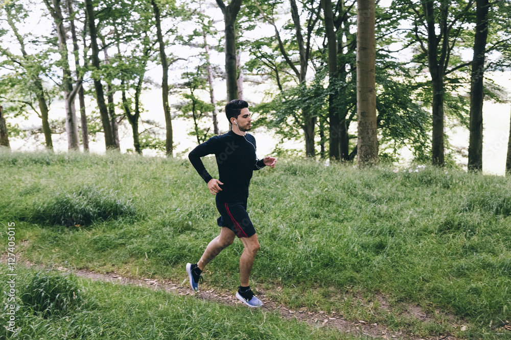 Man running on forest track Man running on forest track