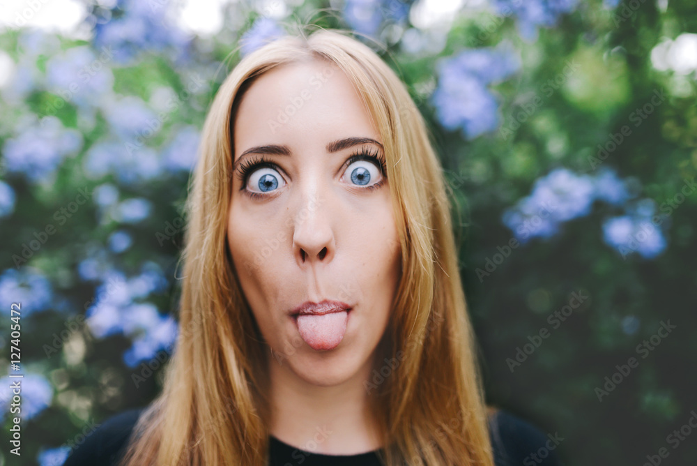 Portrait of a blond woman sticking out tongue Portrait of a blond woman sticking out tongue