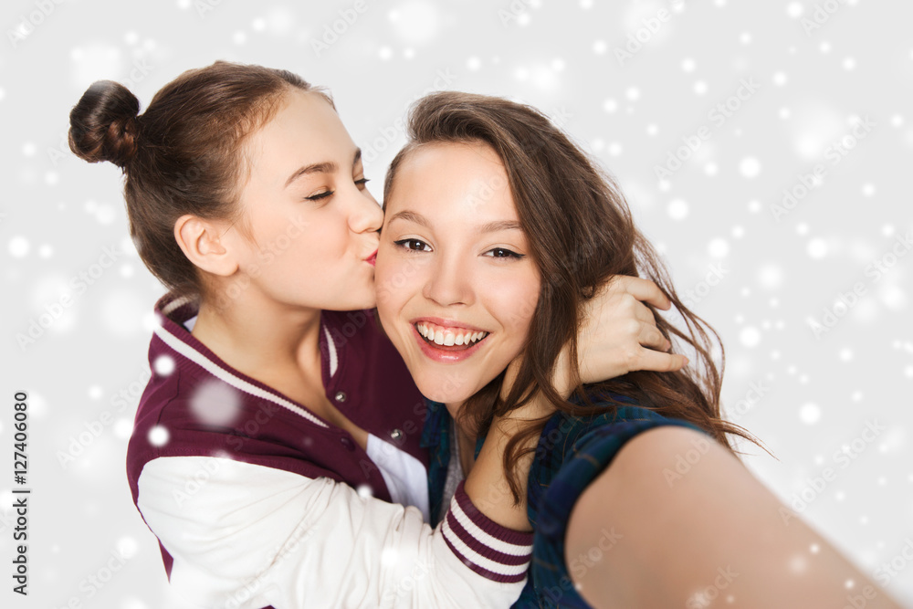 happy teenage girls taking selfie and kissing happy teenage girls taking selfie and kissing