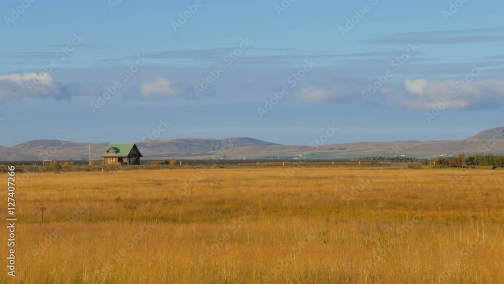 long shot of calm icelandic landscape with small country house, southern coast of Iceland long shot of calm icelandic landscape with small country house, southern coast of Iceland