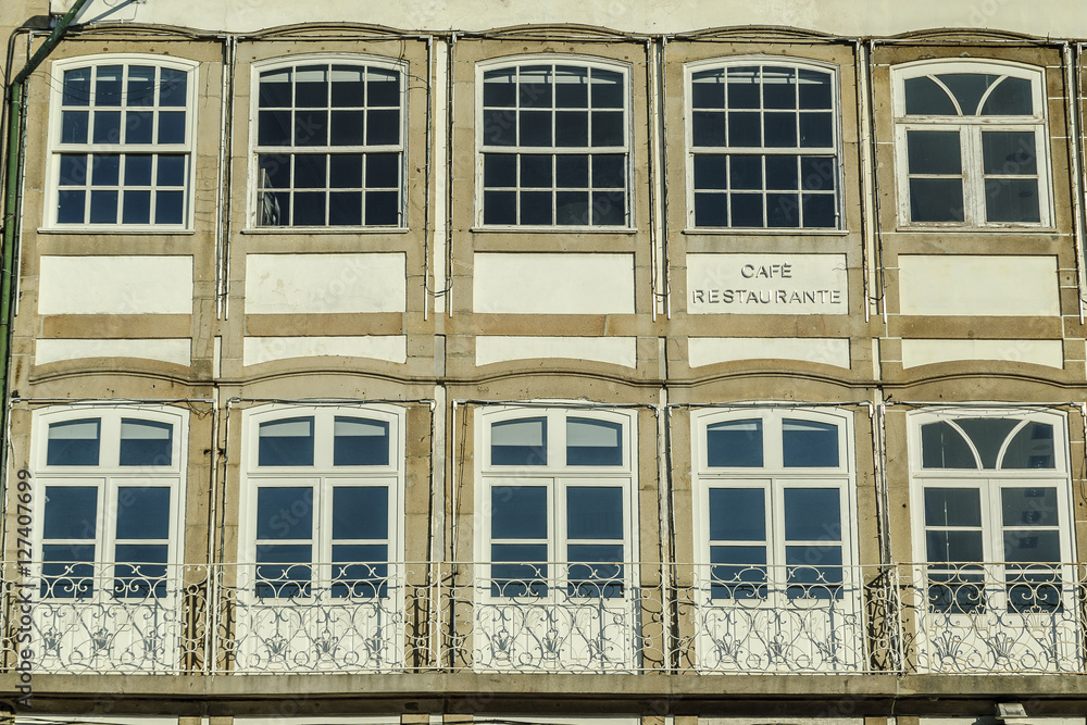 Fototapeta premium traditional large windows of a building in the square of the Toural of Guimaraes's town, Portugal