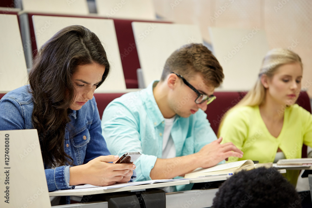 group of students with smartphone at lecture group of students with smartphone at lecture