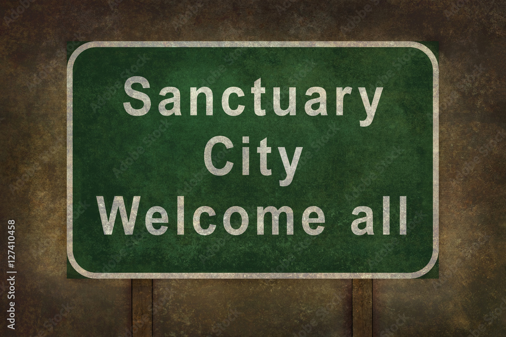 Sanctuary city welcome road sign with ominous background Sanctuary city welcome road sign with ominous background