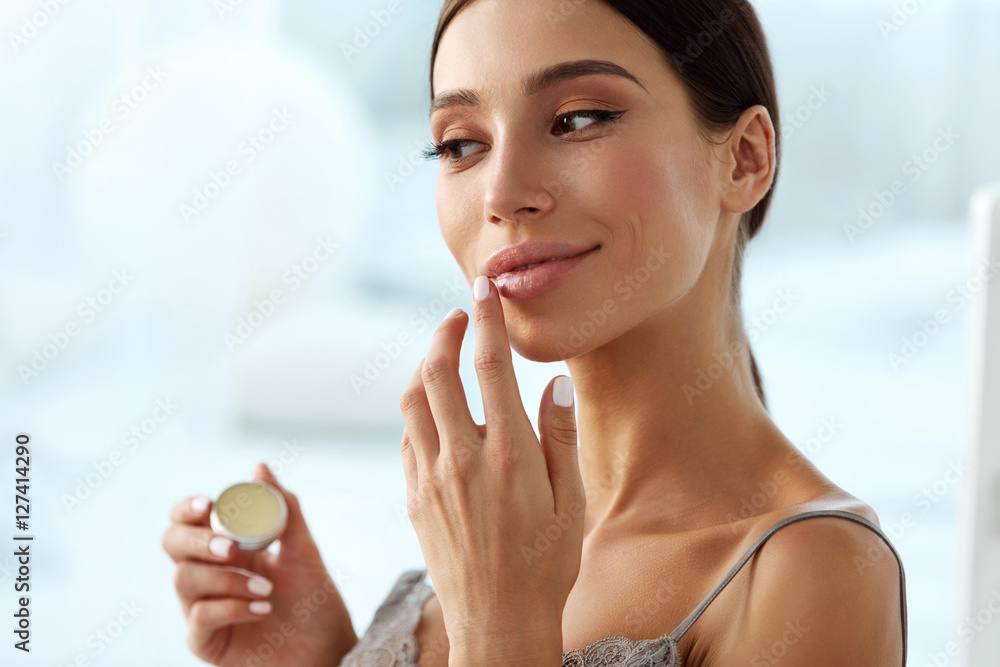 Lips Skin Care. Woman With Beauty Face Applying Lip Balm On - obrazy, fototapety, plakaty 